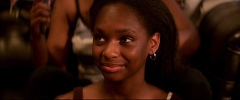 Movie still from “George Washington” (2000), directed by David Gordon Green – A person smiling; Close Up shot, High angle