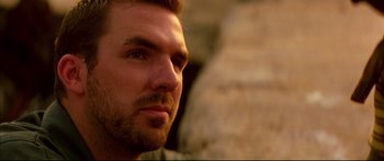 Movie still from “George Washington” (2000), directed by David Gordon Green – A man's face with a stone wall in the background; Close Up shot, Low angle