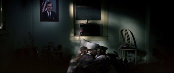 Movie still from “George Washington” (2000), directed by David Gordon Green – Two people laying in a bed in front of an air conditioner; Medium shot, High angle