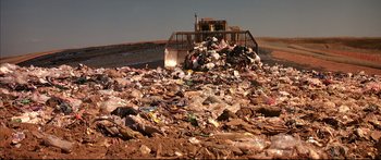 Movie still from “George Washington” (2000), directed by David Gordon Green – A large pile of trash on top of a hill; Extreme Wide shot, High angle