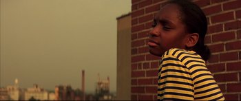Movie still from “George Washington” (2000), directed by David Gordon Green – A young boy in a yellow and black striped t - shirt; Close Up shot, Low angle