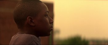 Movie still from “George Washington” (2000), directed by David Gordon Green – A person's face; Close Up shot, Low angle