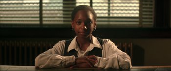 Movie still from “George Washington” (2000), directed by David Gordon Green – A woman sitting at a table with her hands crossed; Close Up shot, Low angle