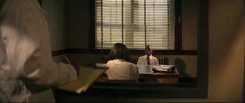Movie still from “George Washington” (2000), directed by David Gordon Green – Two people sitting at a table in front of a window; Wide shot, Over the shoulder angle