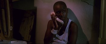 Movie still from “George Washington” (2000), directed by David Gordon Green – A person holding a phone in their hand; Close Up shot, Low angle