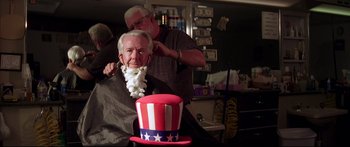 Movie still from “George Washington” (2000), directed by David Gordon Green – An older man getting his hair cut at a barber shop; Close Up shot, Low angle