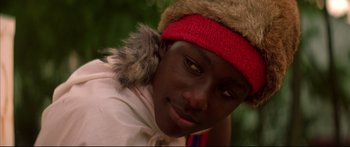 Movie still from “George Washington” (2000), directed by David Gordon Green – A person wearing a red hat and a red scarf; Close Up shot, Low angle