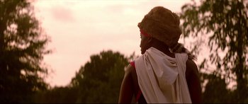 Movie still from “George Washington” (2000), directed by David Gordon Green – A person wearing a hat and a scarf; Close Up shot, Low angle