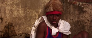 Movie still from “George Washington” (2000), directed by David Gordon Green – A young man wearing a fur hat and a white scarf; Close Up shot, Low angle