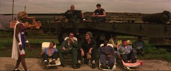 Movie still from “George Washington” (2000), directed by David Gordon Green – A group of men sitting on top of a train car; Wide shot, High angle