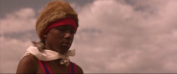 Movie still from “George Washington” (2000), directed by David Gordon Green – A man wearing a hat and a bow tie; Close Up shot, Low angle