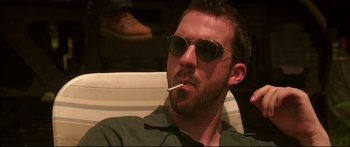 Movie still from “George Washington” (2000), directed by David Gordon Green – A person with sunglasses smoking a cigarette; Close Up shot, Low angle