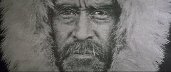 Movie still from “George Washington” (2000), directed by David Gordon Green – An old man with a beard and a fur coat; Extreme Close Up shot, Overhead angle