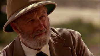 Movie still from “Geronimo: An American Legend” (1993), directed by Walter Hill – An old man with a beard wearing a suit and a hat; Close Up shot, Over the shoulder angle