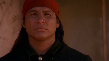 Movie still from “Geronimo: An American Legend” (1993), directed by Walter Hill – A person wearing a red hat; Close Up shot, Low angle