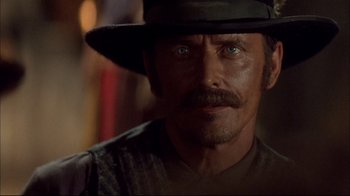 Movie still from “Geronimo: An American Legend” (1993), directed by Walter Hill – A person wearing a hat; Close Up shot, Over the shoulder angle