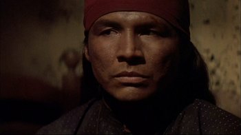 Movie still from “Geronimo: An American Legend” (1993), directed by Walter Hill – A person wearing a red hat; Close Up shot, Low angle