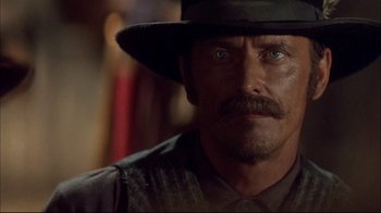 Movie still from “Geronimo: An American Legend” (1993), directed by Walter Hill – A person wearing a hat; Close Up shot, Over the shoulder angle