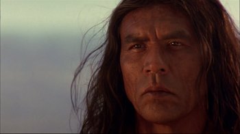 Movie still from “Geronimo: An American Legend” (1993), directed by Walter Hill – A person with long black hair; Close Up shot, Low angle