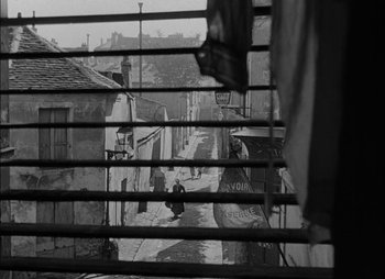 Movie still from “Gervaise” (1956), directed by René Clément – A black and white photo of a city street; Extreme Wide shot, High angle