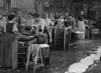 Movie still from “Gervaise” (1956), directed by René Clément – A group of women working in an industrial setting; Wide shot, High angle