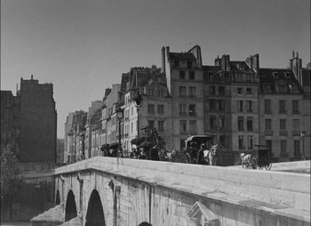 Movie still from “Gervaise” (1956), directed by René Clément – A black - and - white photo of a bridge with horses and carriages on it; Extreme Wide shot, High angle