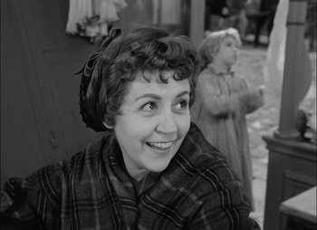 Movie still from “Gervaise” (1956), directed by René Clément – An old photo of an older woman smiling for the camera; Close Up shot, Over the shoulder angle