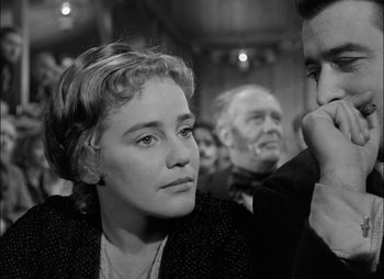 Movie still from “Gervaise” (1956), directed by René Clément – An old photo of a woman and a man in a crowd; Close Up shot, Over the shoulder angle