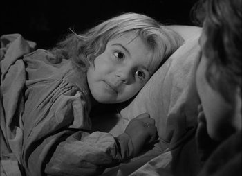 Movie still from “Gervaise” (1956), directed by René Clément – A young girl laying in a bed with a pillow; Close Up shot, High angle