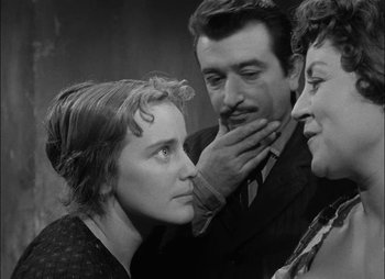 Movie still from “Gervaise” (1956), directed by René Clément – A man and two women looking at each other; Close Up shot, Over the shoulder angle