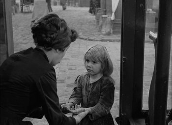 Movie still from “Gervaise” (1956), directed by René Clément – An old photo of a woman and a little girl; Medium shot, Over the shoulder angle