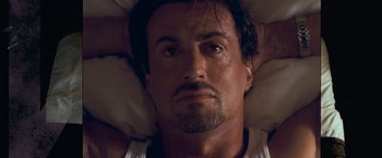 Movie still from “Get Carter” (2000), directed by Stephen Kay – A man laying in a bed with his eyes wide open; Close Up shot, Overhead angle