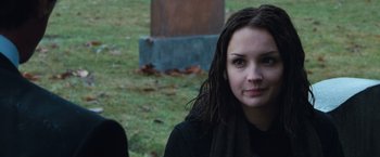 Movie still from “Get Carter” (2000), directed by Stephen Kay – A young woman sitting in front of a statue; Close Up shot, Over the shoulder angle