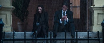 Movie still from “Get Carter” (2000), directed by Stephen Kay – A man and a woman sitting next to each other; Wide shot, Low angle