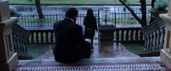 Movie still from “Get Carter” (2000), directed by Stephen Kay – A man sitting on the ground next to a woman; Wide shot, Low angle