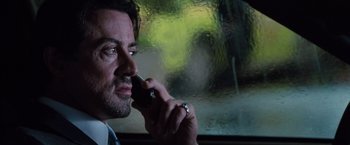 Movie still from “Get Carter” (2000), directed by Stephen Kay – A person talking on a cell phone; Close Up shot, Low angle