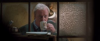 Movie still from “Get Carter” (2000), directed by Stephen Kay – An older man is drinking a cup of coffee; Close Up shot, Low angle