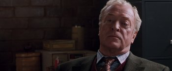 Movie still from “Get Carter” (2000), directed by Stephen Kay – An older man wearing a suit and tie; Close Up shot, Low angle