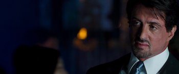 Movie still from “Get Carter” (2000), directed by Stephen Kay – A blurry picture of a person in a dark room; Close Up shot, Over the shoulder angle