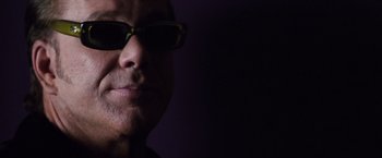 Movie still from “Get Carter” (2000), directed by Stephen Kay – A person wearing sunglasses; Close Up shot, Low angle