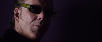 Movie still from “Get Carter” (2000), directed by Stephen Kay – A person wearing sunglasses; Close Up shot, Low angle