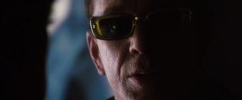 Movie still from “Get Carter” (2000), directed by Stephen Kay – A person wearing sunglasses; Extreme Close Up shot, Low angle