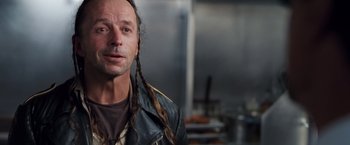 Movie still from “Get Carter” (2000), directed by Stephen Kay – A man in a leather jacket with long braids; Close Up shot, Low angle