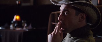 Movie still from “Get Carter” (2000), directed by Stephen Kay – A man in a cowboy hat is smoking a cigarette; Close Up shot, Low angle