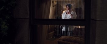 Movie still from “Get Carter” (2000), directed by Stephen Kay – A man in a white shirt is looking in a mirror; Medium shot, High angle