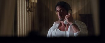 Movie still from “Get Carter” (2000), directed by Stephen Kay – A man talking on a phone while wearing a white shirt; Close Up shot, Low angle