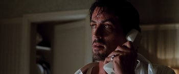 Movie still from “Get Carter” (2000), directed by Stephen Kay – A person talking on a cell phone; Close Up shot, Low angle