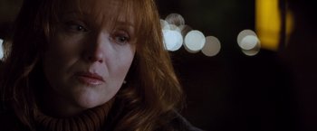 Movie still from “Get Carter” (2000), directed by Stephen Kay – A woman's face with lights in the background; Close Up shot, Over the shoulder angle