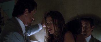 Movie still from “Get Carter” (2000), directed by Stephen Kay – A woman getting her hair combed by a man; Close Up shot, Over the shoulder angle