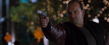 Movie still from “Get Carter” (2000), directed by Stephen Kay – A man in a leather jacket holding a gun in his right hand; Close Up shot, Low angle